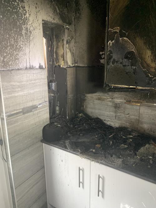 Image shows a kitchen that has been burnt in a fire