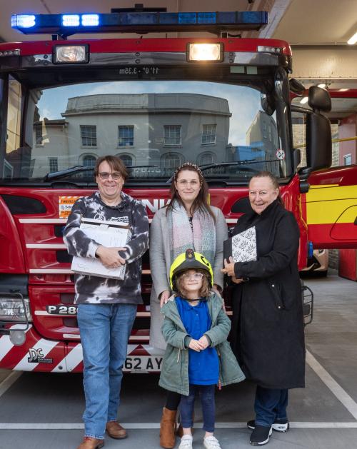 The Scrivens family with the album in front of a fire engine