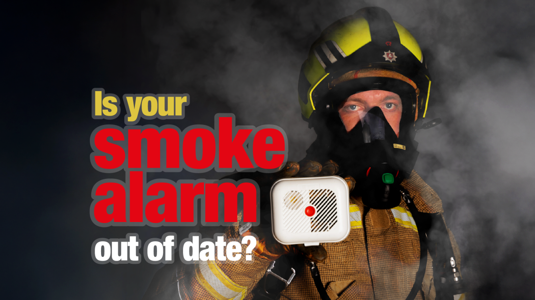 Firefighter in breathing apparatus holding an older style smoke alarm with the caption "Is your smoke alarm out of date?"