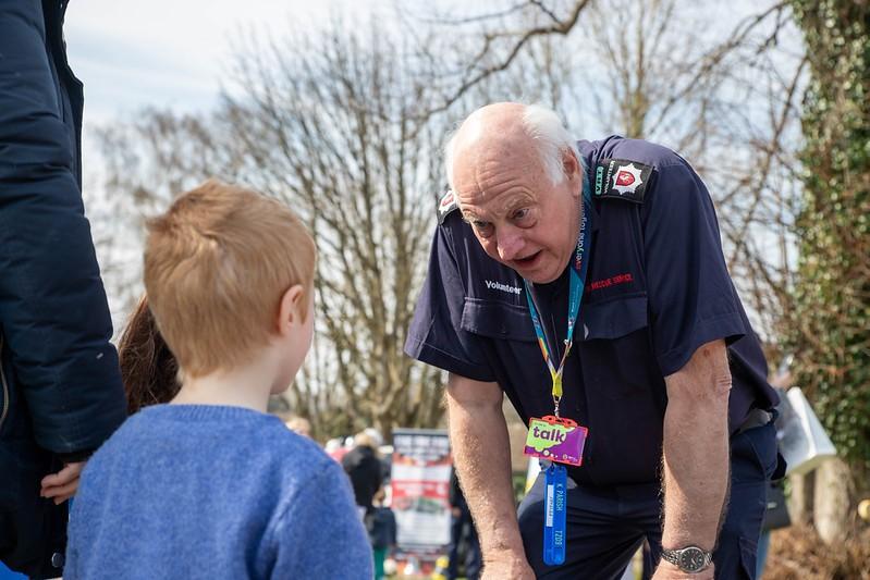 Volunteer talking to a young boy