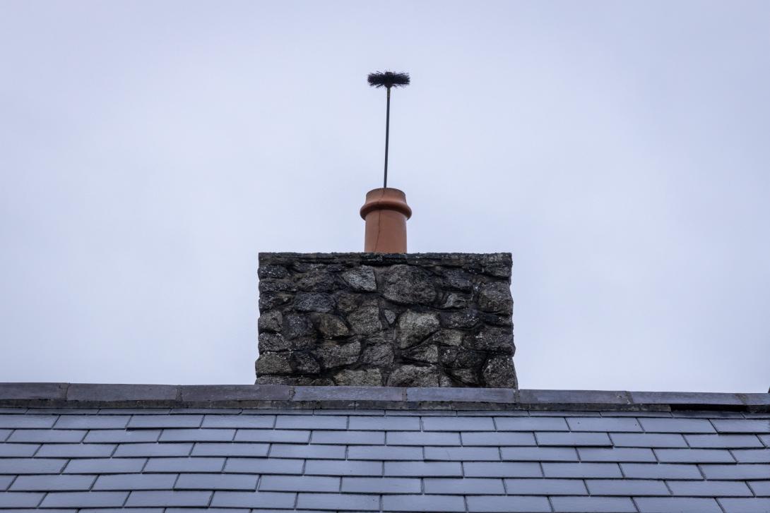 chimney brush sticking out of a chimney