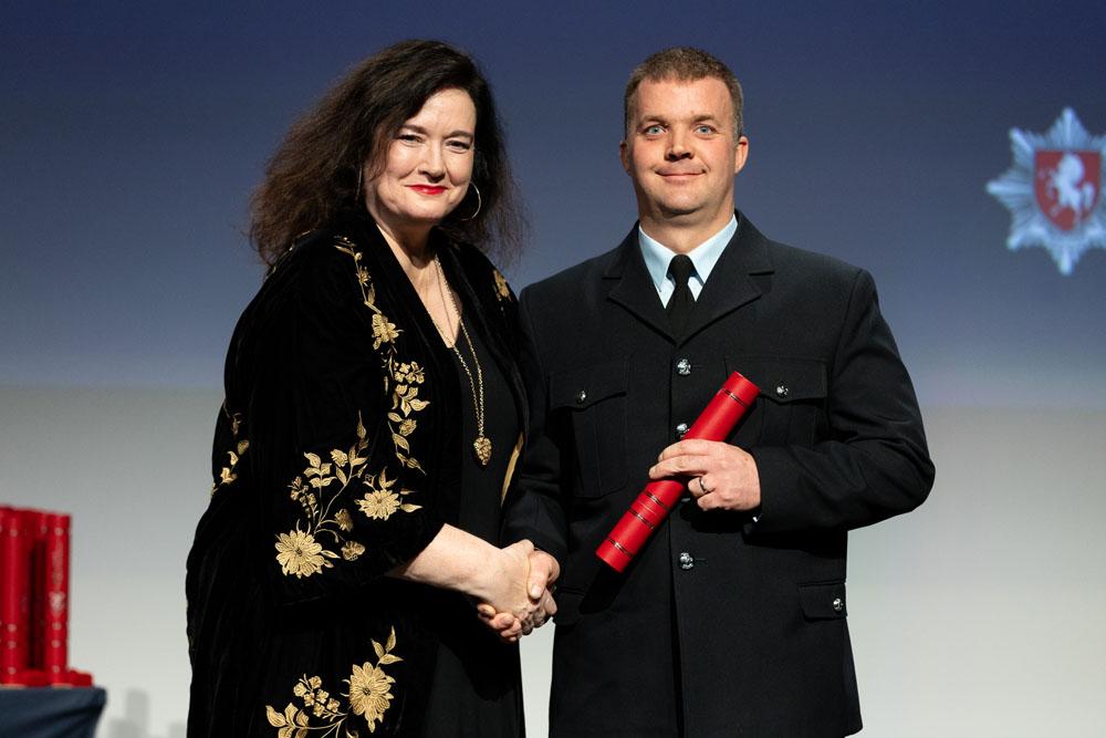 Firefighter Ian collecting his award