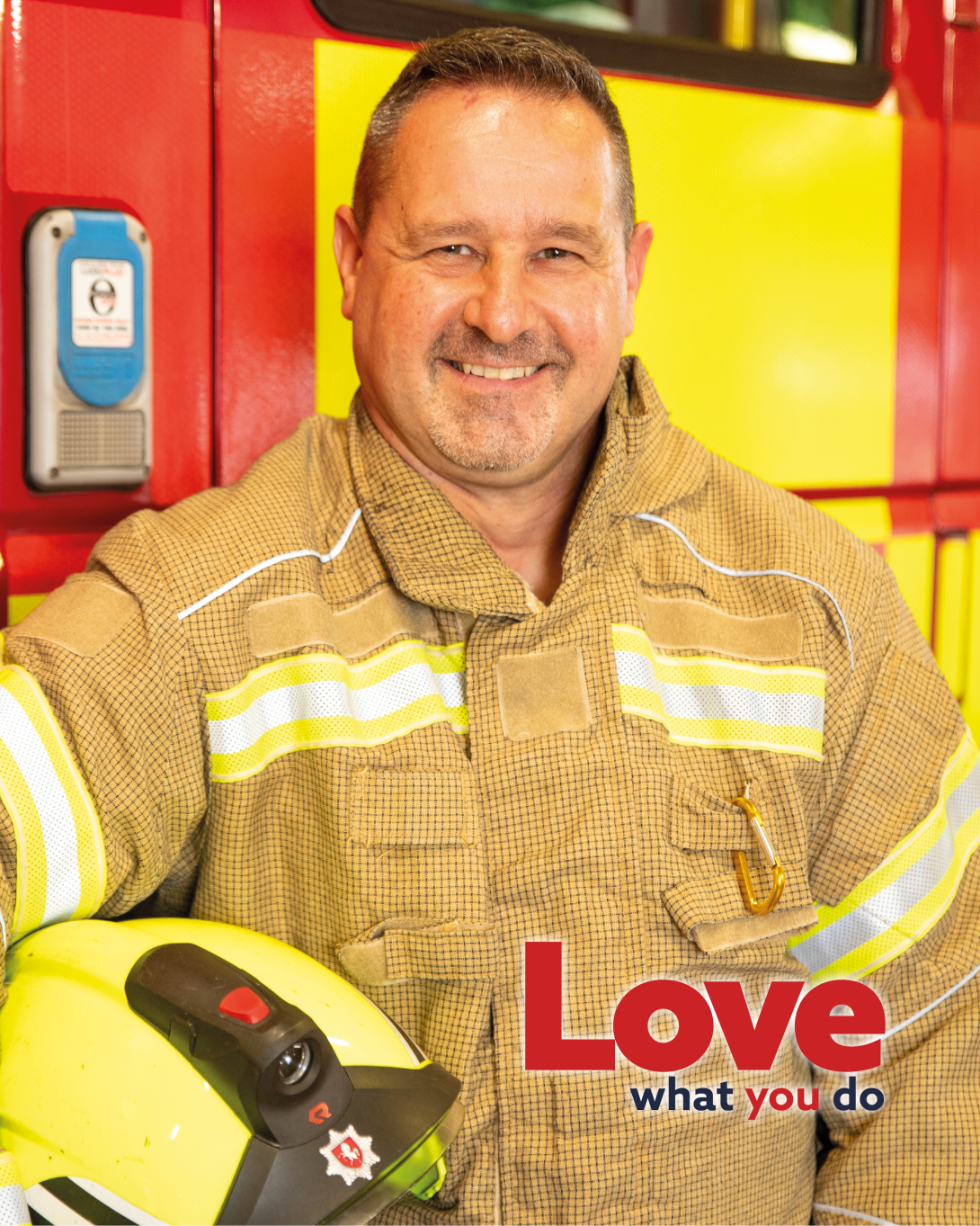 Craig, an on-call firefighter, stood in full gear in front of a fire engine