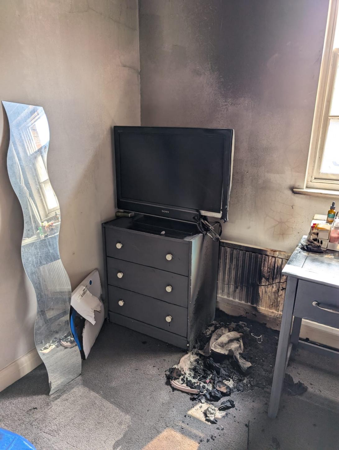 Damage to a bedroom caused by a fire from a vanity mirror